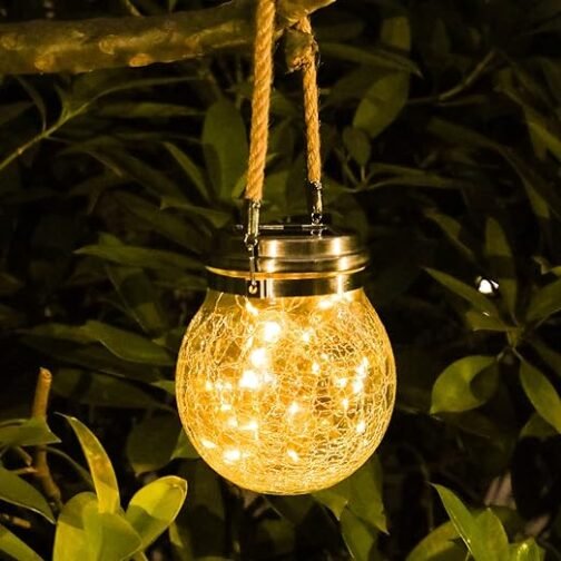 Glowing solar-powered hanging light in a garden at night